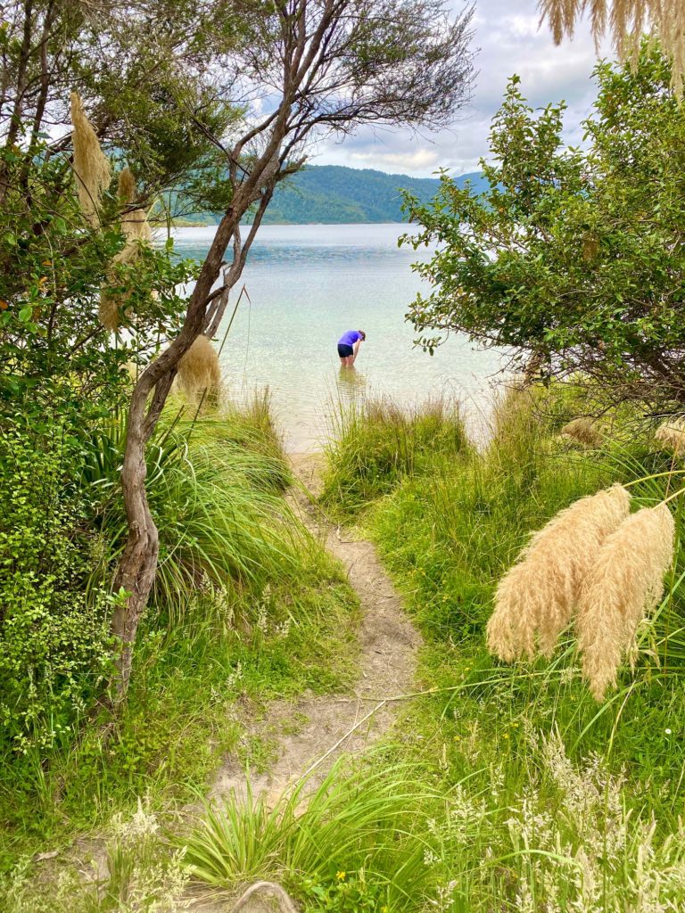 Hiker cooling their legs in Lake Waikaremoana